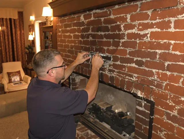 Ridgefield Chimney Sweep expert fixing a fireplace in Ridgefield, CT